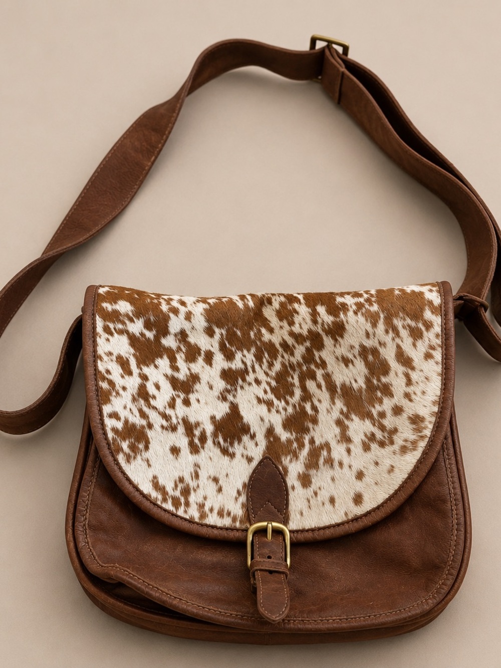 Genuine cowhide and leather crossbody bag.
